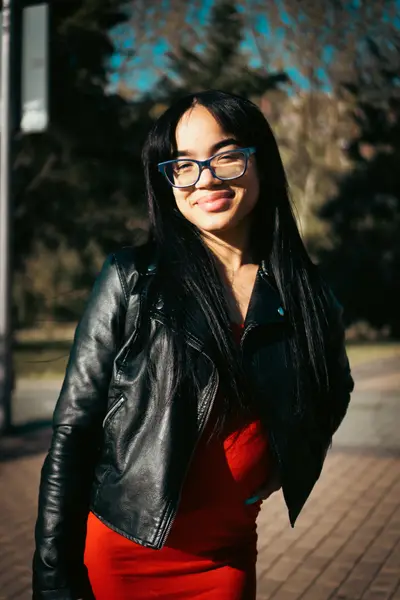 Book de mujer con chaqueta de cuero en un exterior de Madrid